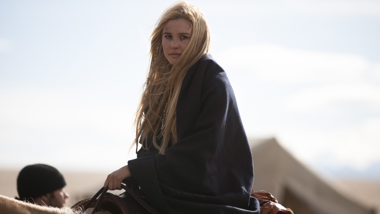 Isabel May sits on a horse, wrapped in a blanket.