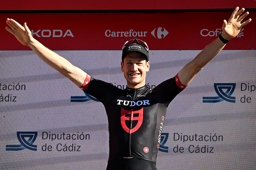 Stefan Kung of Switzerland and Team Tudor Pro Cycling celebrates at podium as stage 18 winner