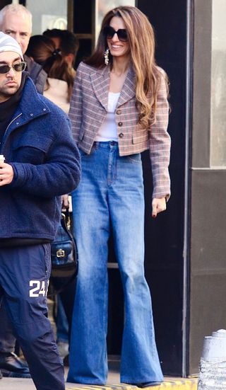 Amal Clooney wearing baggy wide-leg jeans.