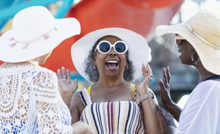 A woman laughs with friends