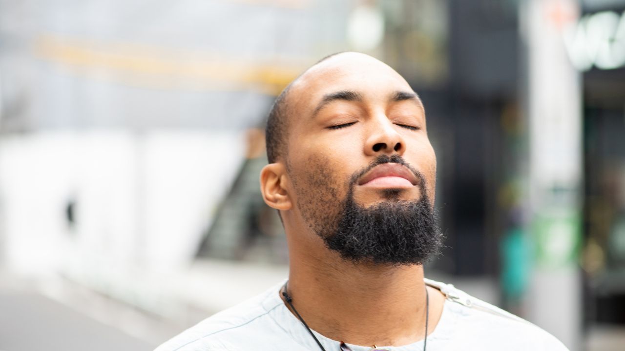 Man taking in the sunlight, suffering from Seasonal Affective Disorder