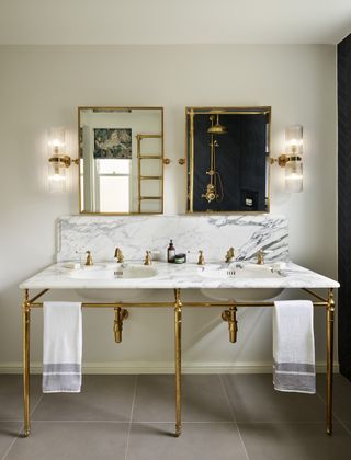White and gold bathroom with traditional vanity