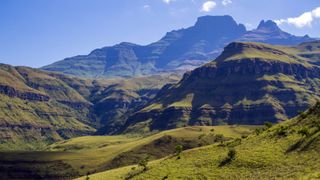 A photo of green rolling hills and mountains