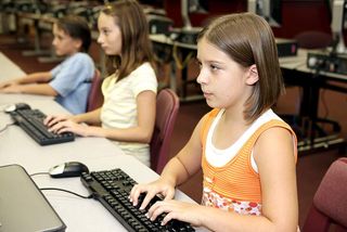 Kids typing at computers.