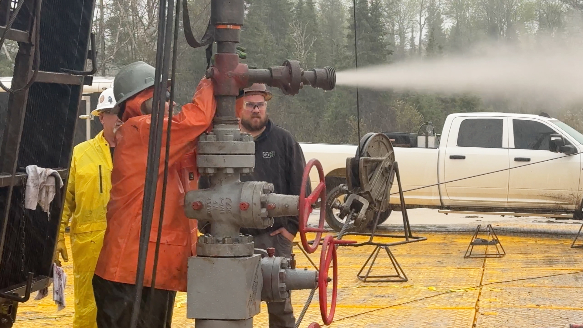 Workers conduct a test of high-pressure helium coming out of a pipe