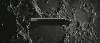 An still image from an artist's depiction of SpaceX's Big Falcon Rocket spaceship flying over the lunar surface. The spacecraft's deployable fins can be seen near the nose.