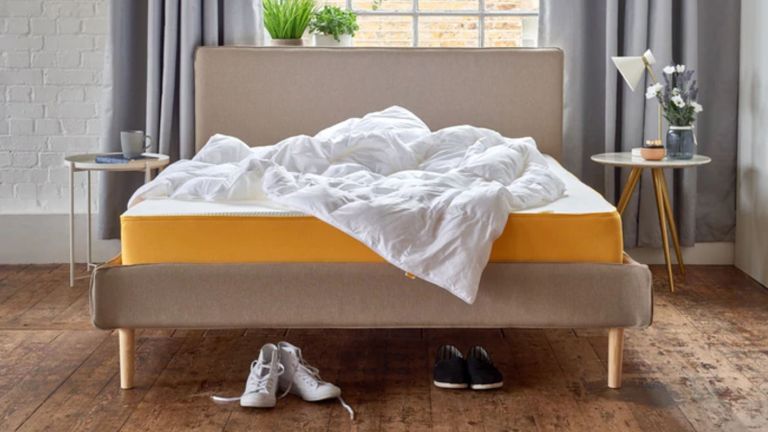 Eve cool:warm best duvet on mustard coloured bed with shoes below and duvet on top lifestyle image
