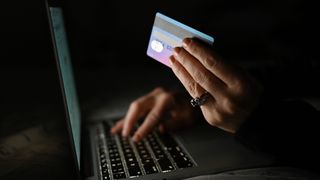 An illustrative image of a person holding a credit card while shopping on-line on a computer, in an apartment during the coronavirus pandemic. On Tuesday, January 11, 2021, in Edmonton, Alberta, Canada. (Photo by Artur Widak/NurPhoto via Getty Images)