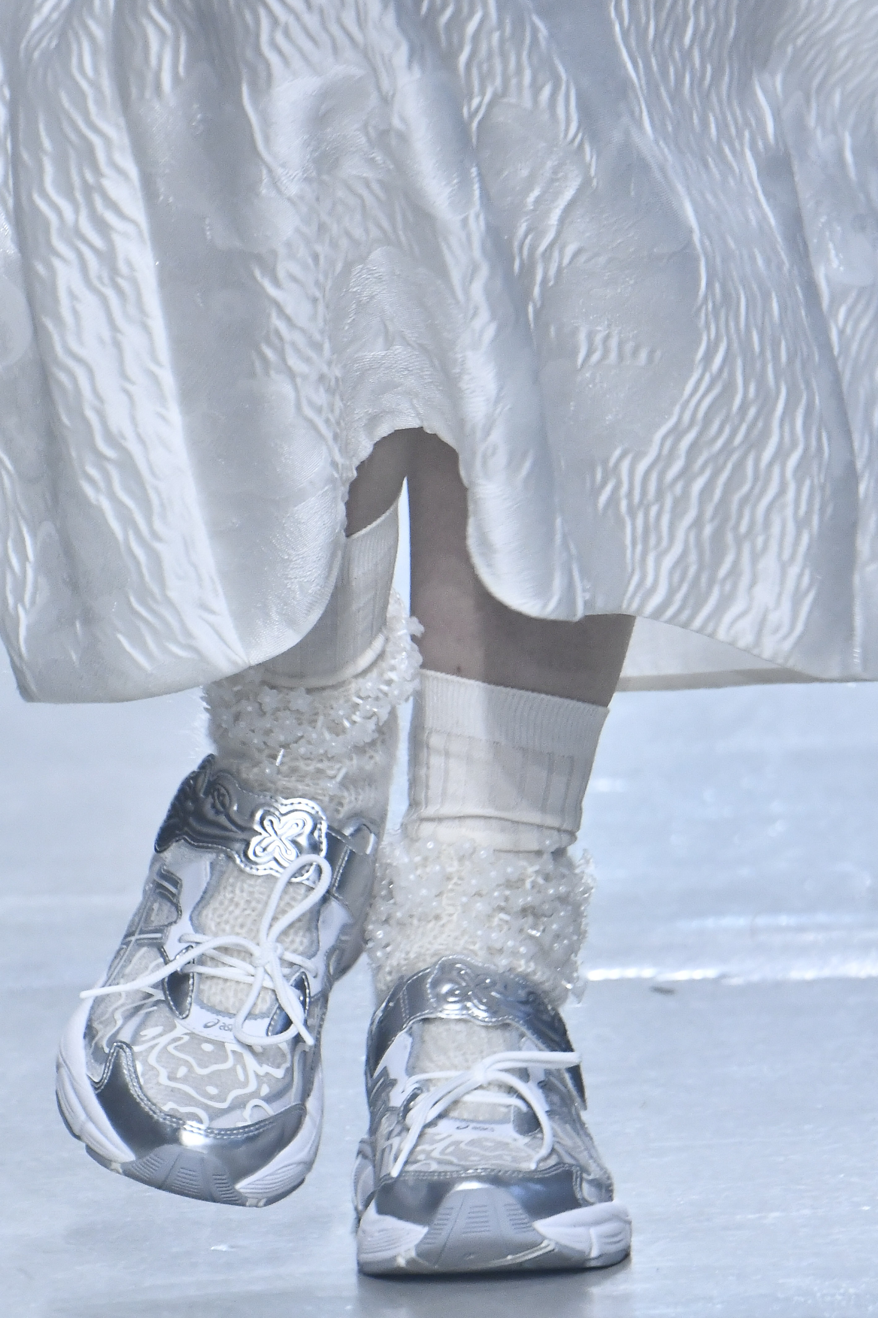 a model wears Cecilie Bahnsen for asics sneakers with floral crew socks