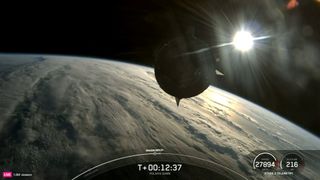 a space capsule orbits earth with the sun in the background