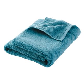 A blue folded bath towel