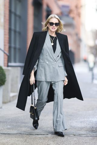 Naomi Watts wearing a grey suit