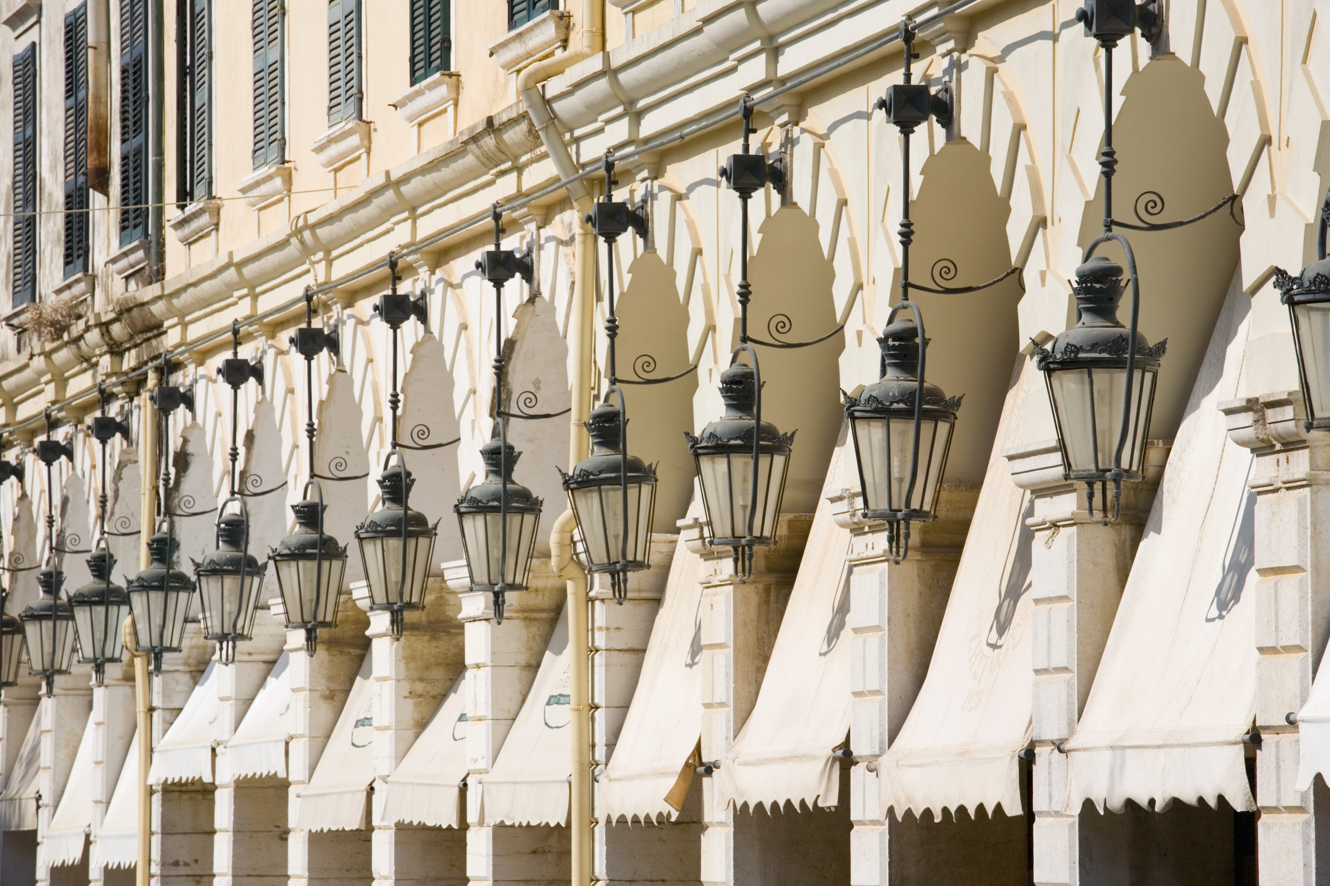 View along row of elegant lamps and awnings lining the Liston, Corfu Town, Corfu