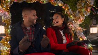 (L-R) Devale Ellis as Teddy and Christina Milian as Layla in "Meet Me Next Christmas"