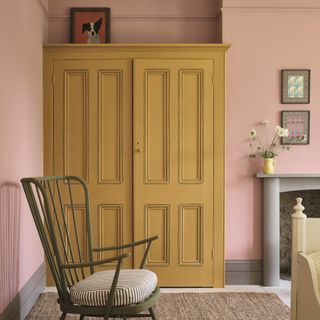 Pink bedroom with ochre wardrobes