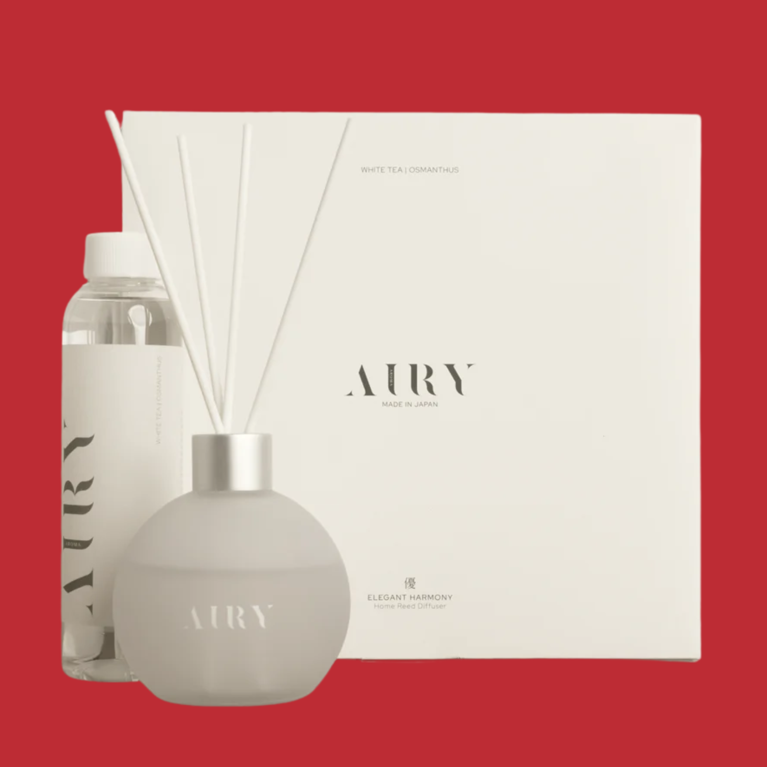A reed diffuser pack against a maroony red backdrop