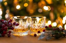 Two glasses of whisky on table with festive decorations