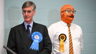 Conservative candidate Jacob Rees-Mogg stands next to Barmy Brunch from The Official Monster Raving Loony Party during the declaration for the North East Somerset constituency