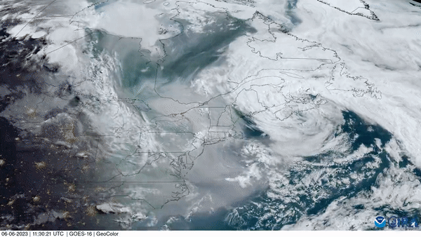 Satellite imagery showing a vortex of low pressure funneling wildfire smoke from Canada to the U.S. Northeast.