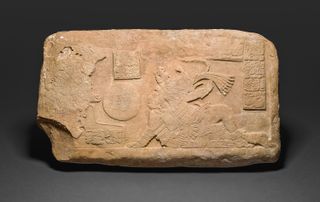 This relief on limestone dating to A.D. 700-800 shows two Maya men, dressed in elaborate costumes, playing a ritual ballgame.