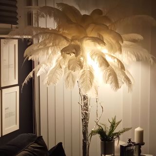 living room with white feather lamp and candle