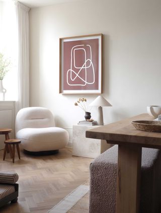 a neutral room with a comfy chair in the corner
