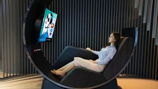 LG Media Chair on display at showroom with woman sitting in it