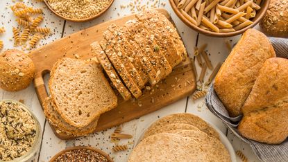 Brown bread on cutting board - stock photo