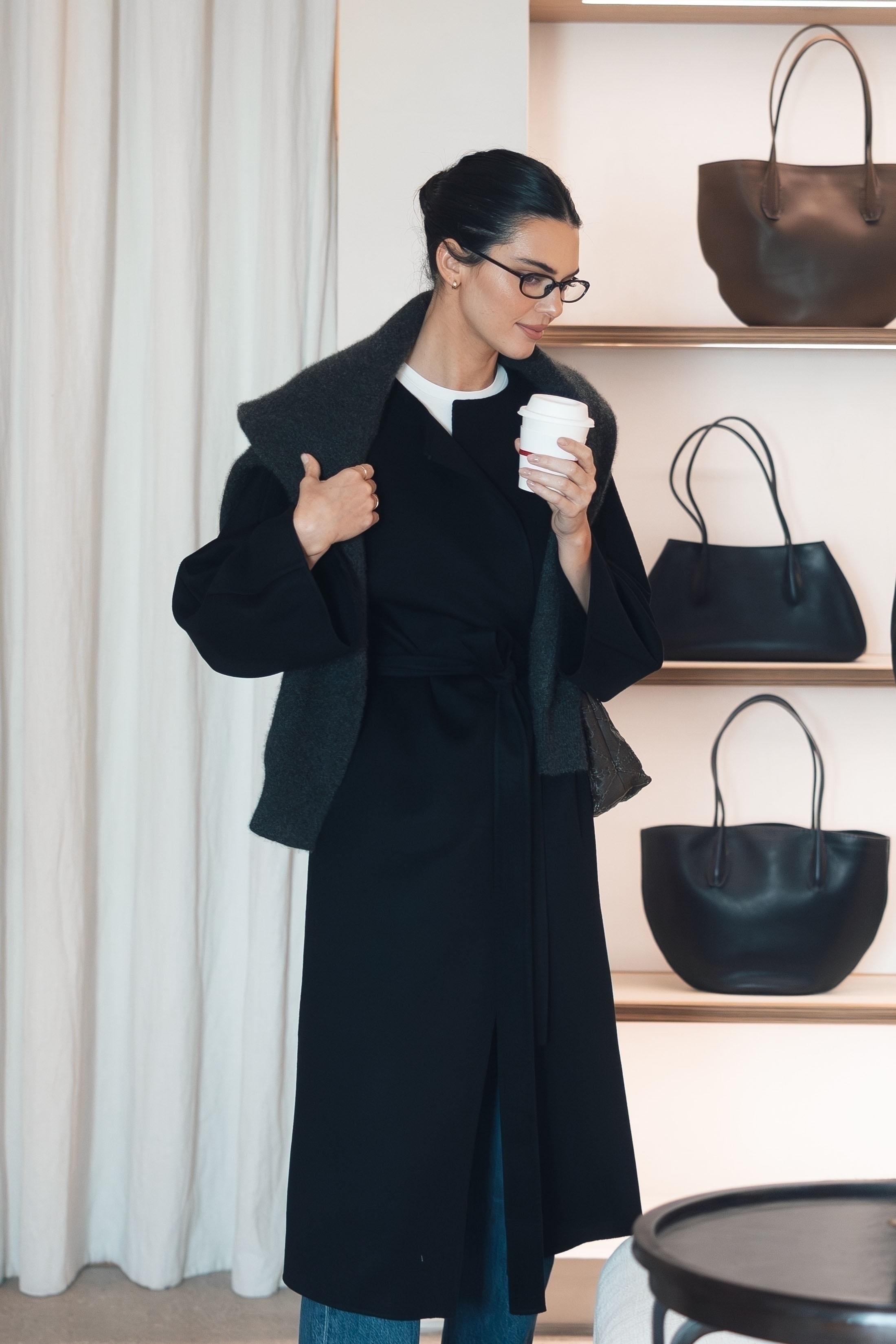 Kendall Jenner wearing a sweater over a wool coat in October 2025