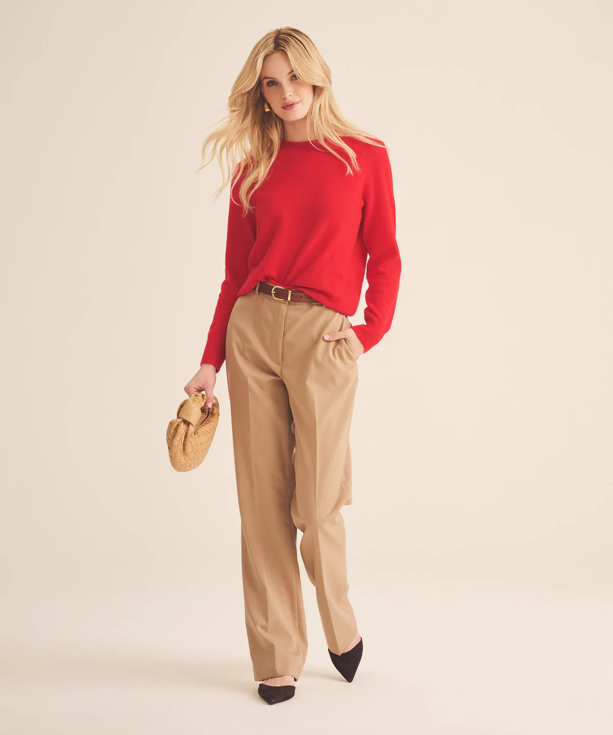 Model wears red cashmere sweater and khaki pants