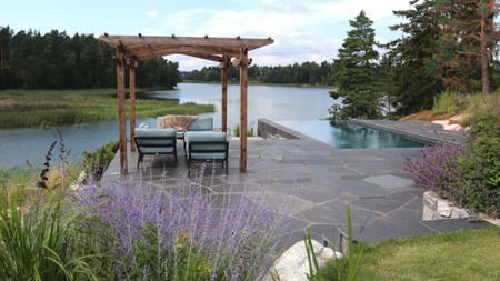 beautiful patio garden with a pool overlooking a lake