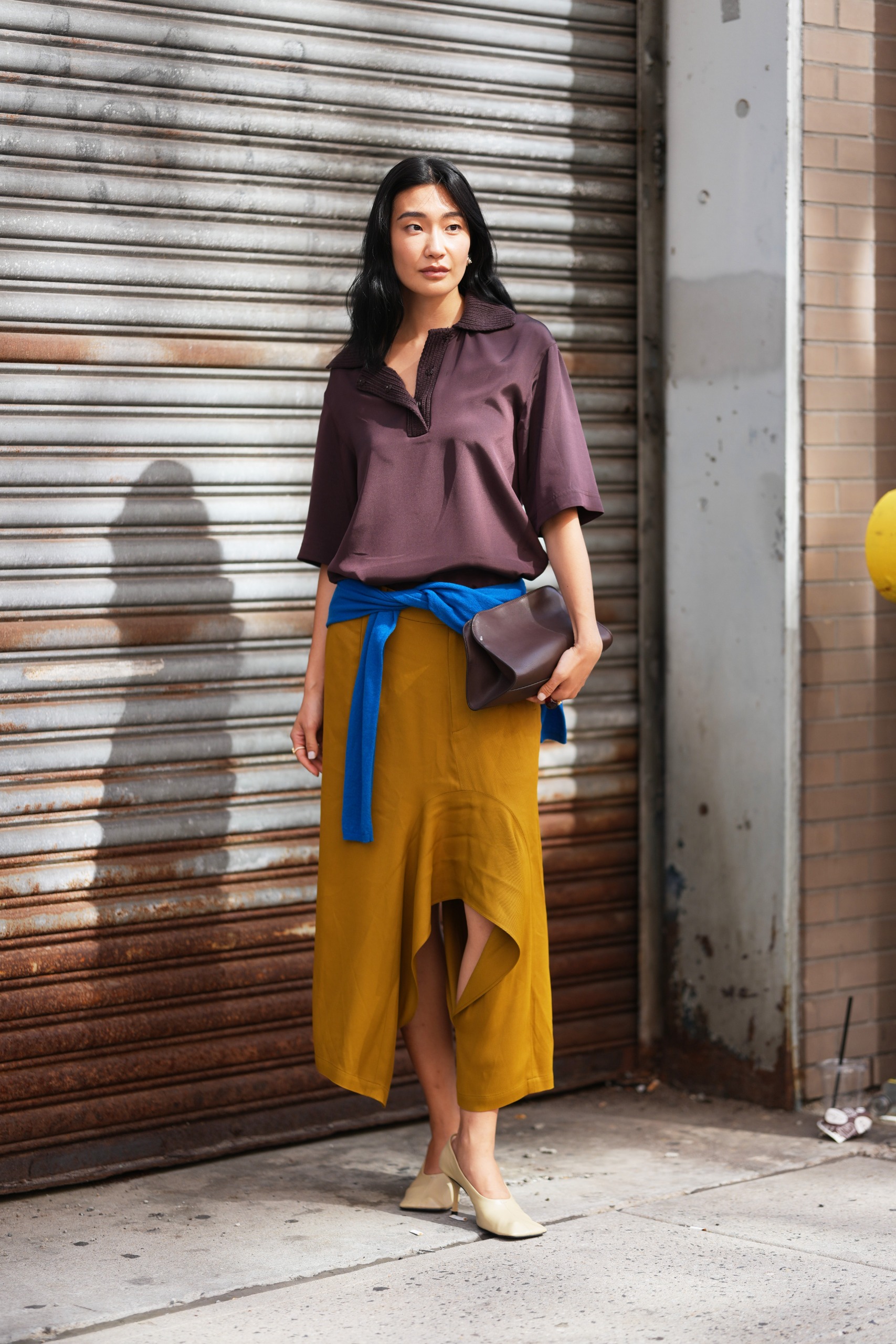 Women wearing a brown polo short sleeve knit top and blue knit tied at the waist