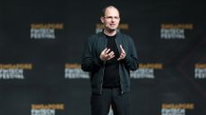 GitHub CEO Thomas Dohmke pictured speaking on stage at the 2023 Singapore FinTech Festival.