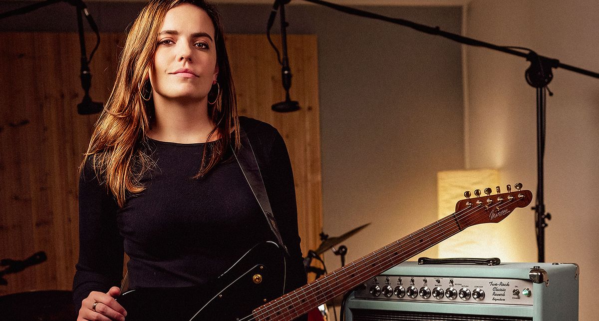 Marty Spender postes in the studio alongside her Two Rock Classic Reverb tube amp in seafoam green tolex.