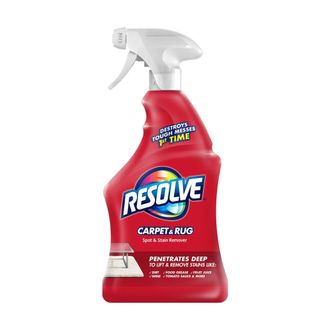 A side on view of a red bottle of carpet stain remover with a white spray lid