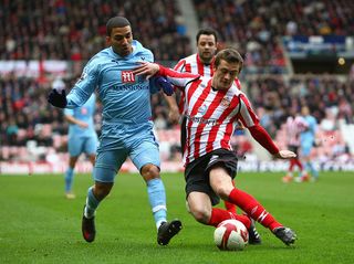 George McCartney of Sunderland tackles Aaron Lennon of Tottenham Hotspur during the Barclays Premier League match between Sunderland and Tottenham Hotspur at The Stadium of Light on March 7, 2009 in Sunderland, England.