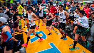 Runners cross the start line of the 2023 Boston Marathon