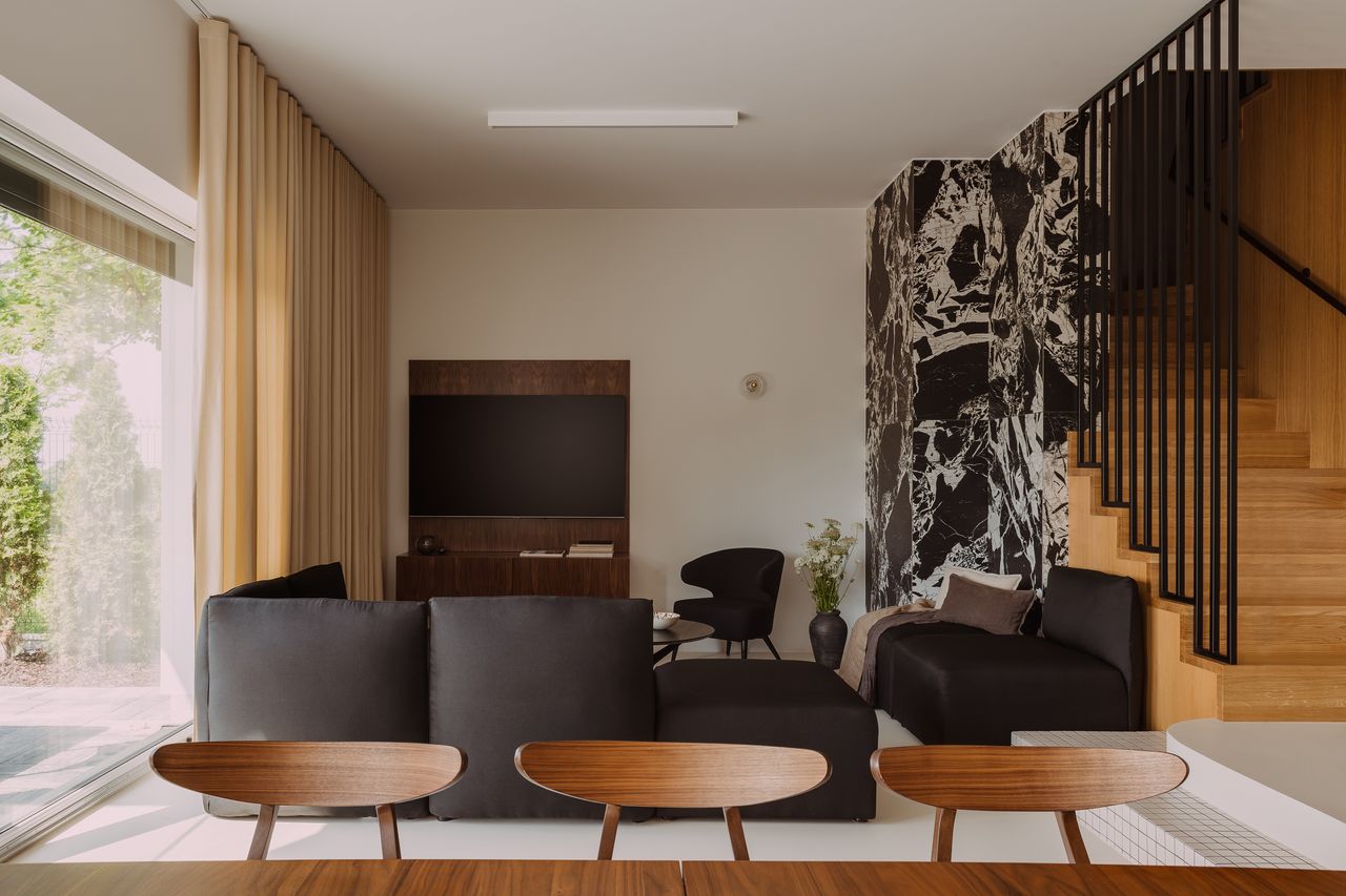 a living room with a large marble wall