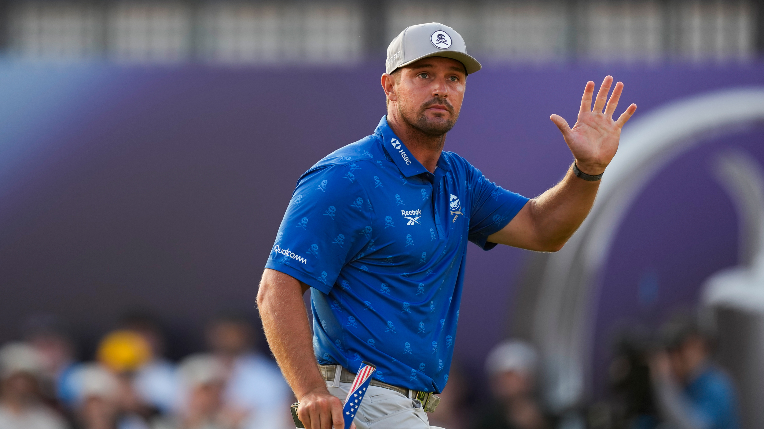 Bryson DeChambeau waves to the crowd at The Open
