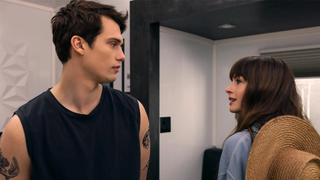 Nicholas Galitzine as Hayes and Anne Hathaway as Soléne in The Idea of You when the characters first meet in Hayes' trailer at Coachella