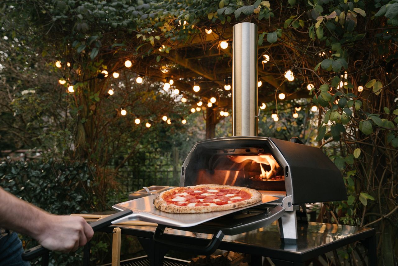 Ooni Karu 16 cooking pizza in the backyard