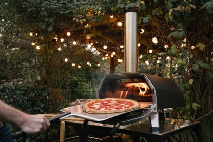 Ooni Karu 16 cooking pizza in the backyard