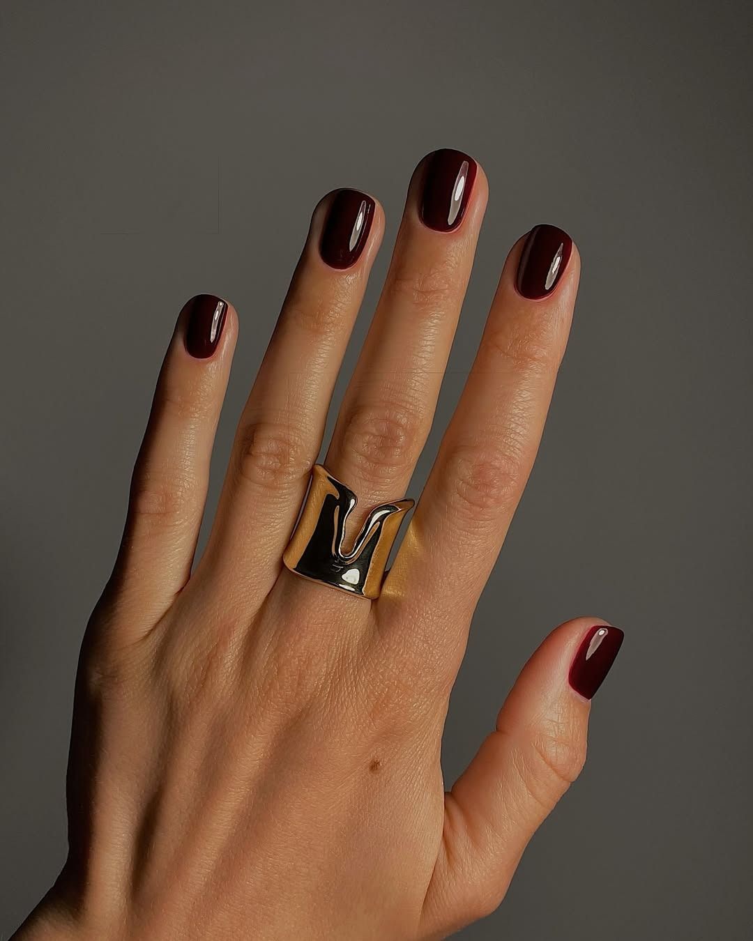 Dark plum nails.