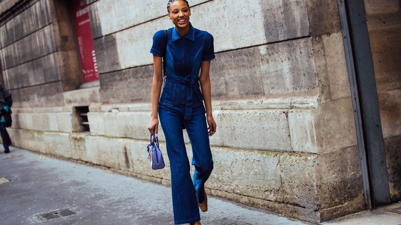 Fashion week attendees wears a denim jumpsuit