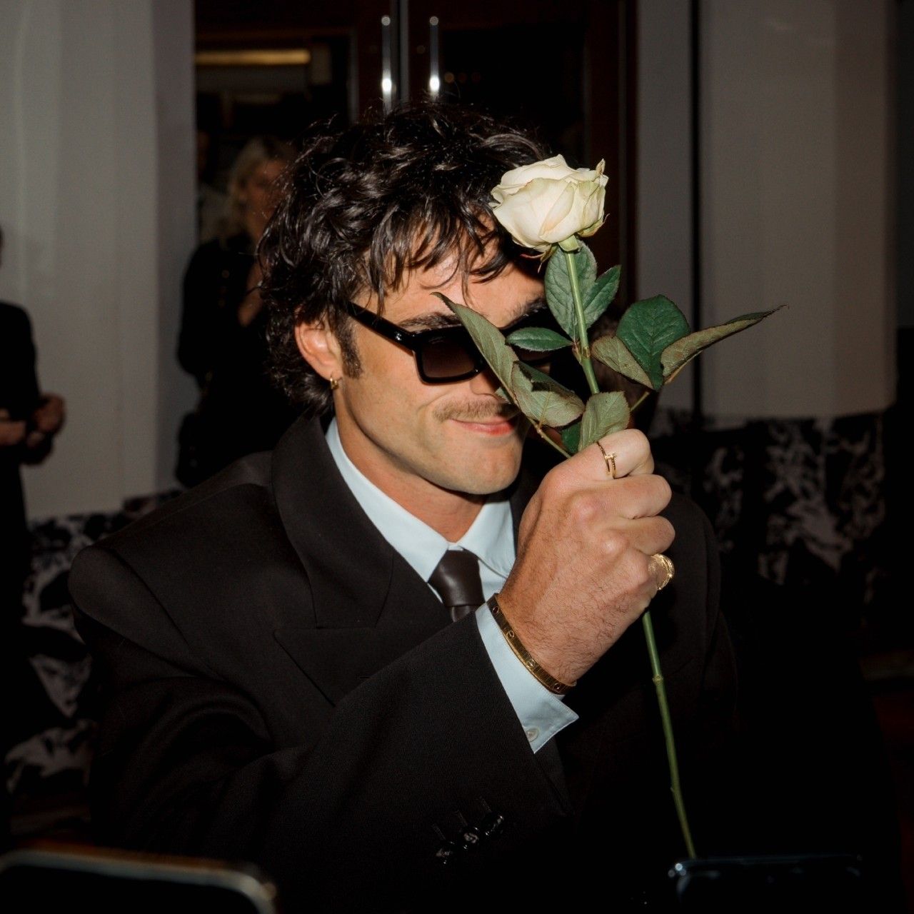 Photo of Jacob Elordi with a white rose
