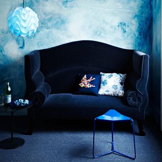 living room with midnight blue velvet sofas cushions and table