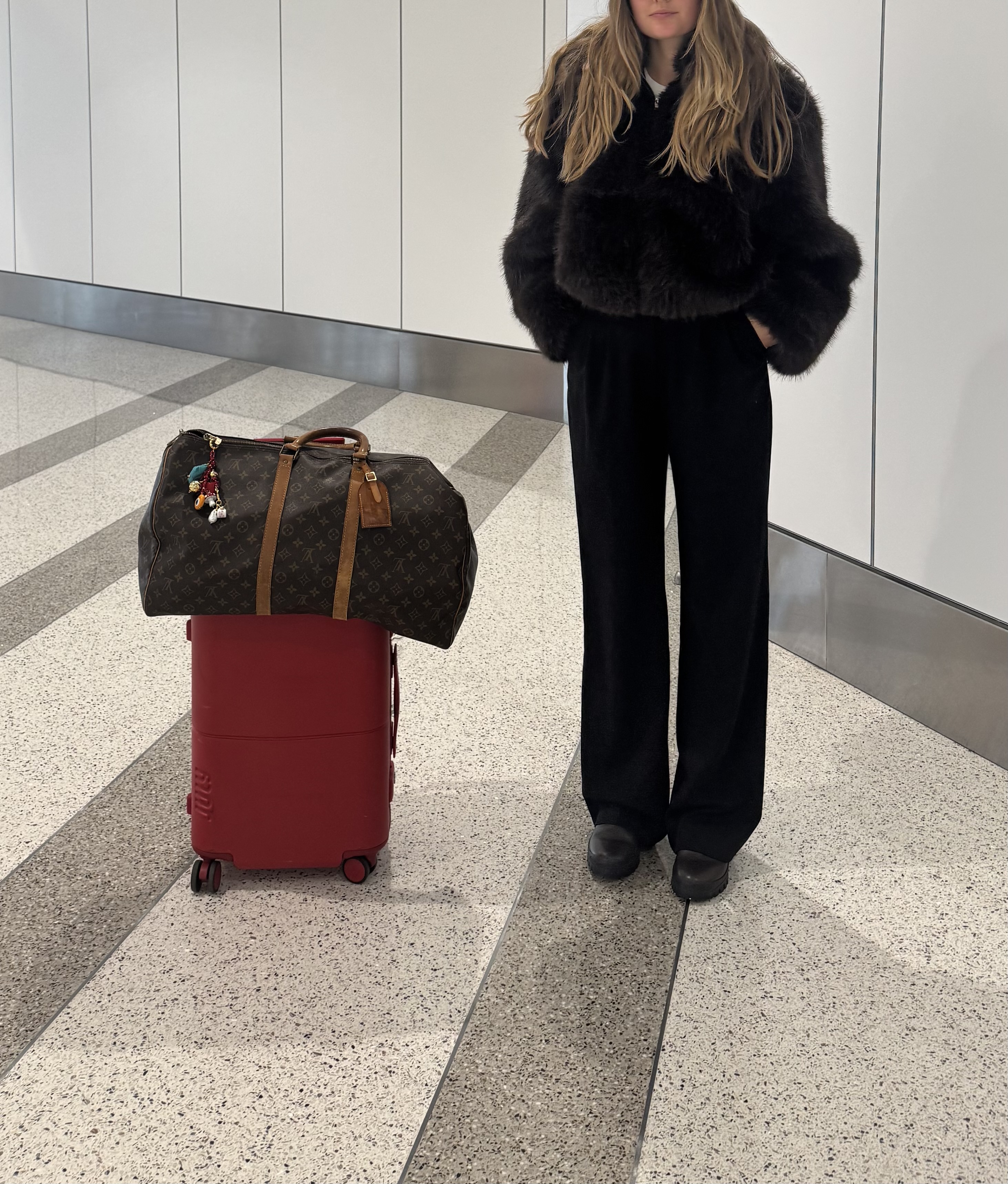 Sara Walker wearing black pants and faux-fur jacket.