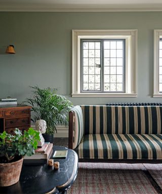 Green and white stripped sofa, green walls