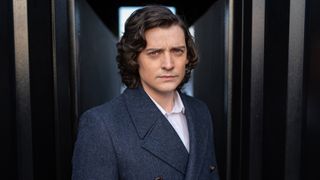 Aneurin Barnard in a double-breasted gray coat for Doctor Who season 14