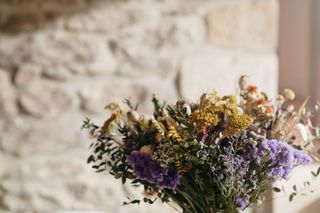 Yellow, lilac and green dried flowers arrangement.